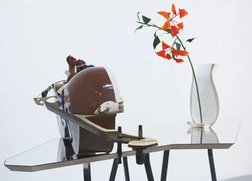 A flower vase and music instrument placed on the table