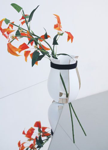 A flower vase placed on the mirror table