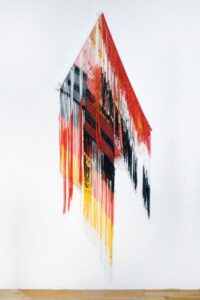 Red, black, yellow hanging fringe textile art