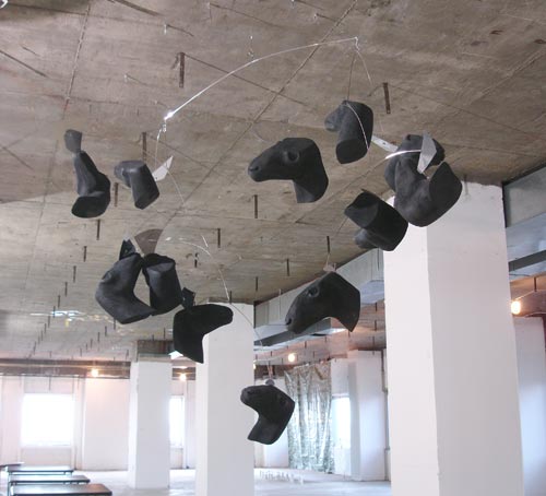 Hanging black abstract sculpture mobile in gallery