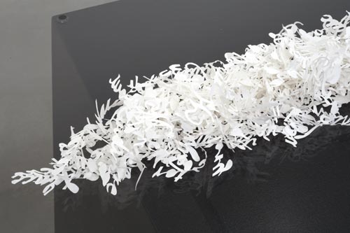 White shredded paper pile on black surface