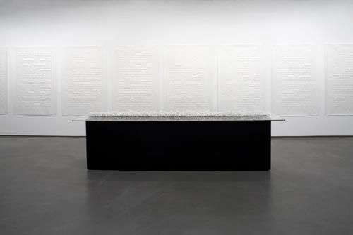 Minimalist black pedestal with white wall panels