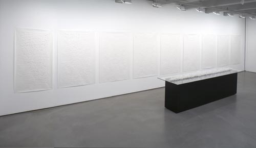 Minimalist gallery installation with white textured panels