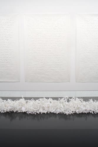 White textured panels with shredded paper installation