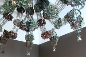 A chandelier with many leaves hanging from the ceiling.