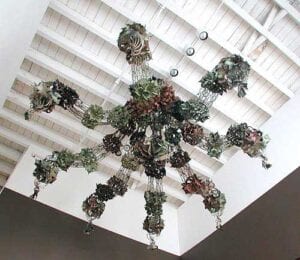 A chandelier with many glass flowers hanging from the ceiling.