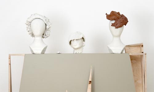 Three wig heads placed on table